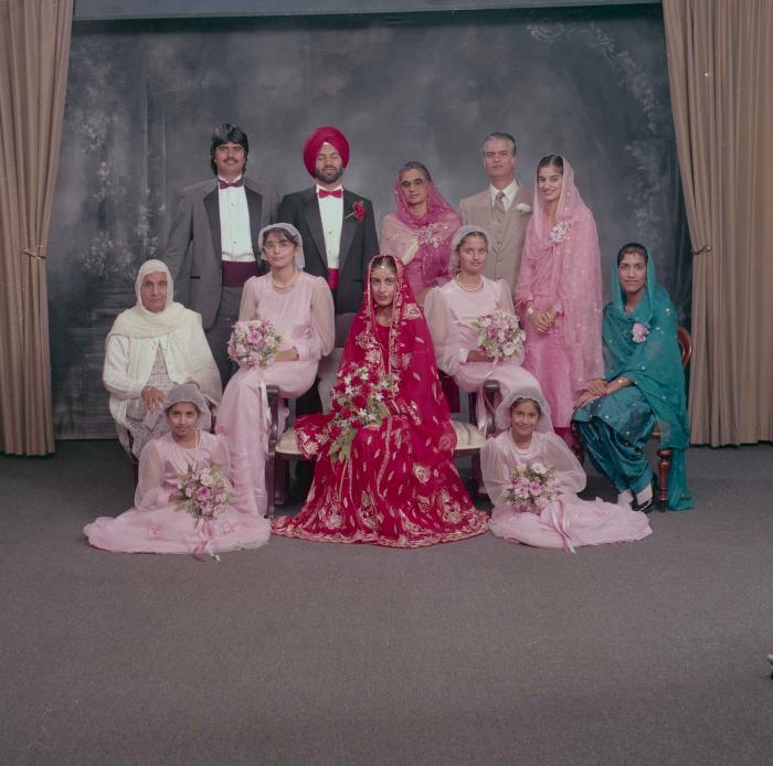 [Photo of Charan Kaila and Karmjit Gill with the their family members]