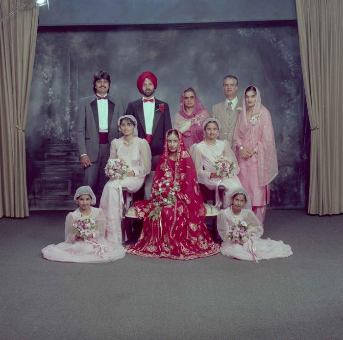 [Group photo of Charan Kaila and Karmjit Gill with their family members]