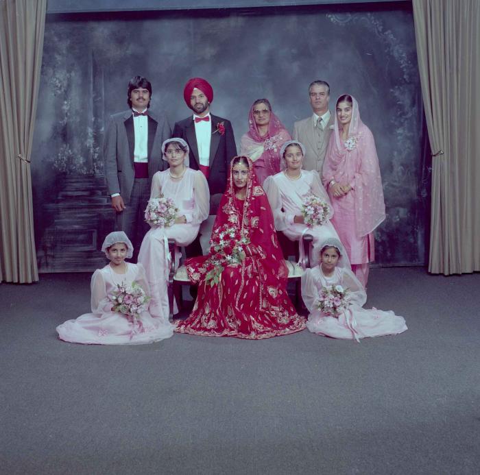 [Group photo of Charan Kaila and Karmjit Gill with their family members]