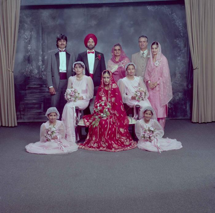 [Group photo of Charan Kaila and Karmjit Gill with their family members]