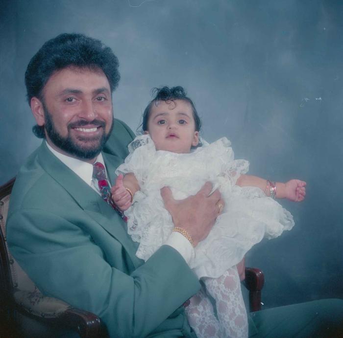 [Photo of an unidentified man and baby]