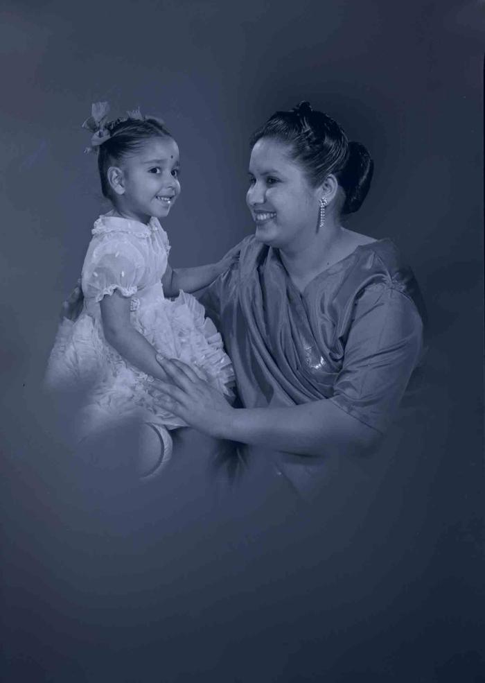 [Photo of Sarjit Kaur with a young child]