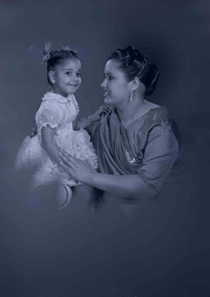 [Photo of Sarjit Kaur with a young child]