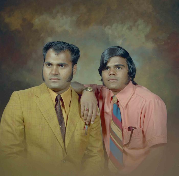 [Photo of two unidentified men]