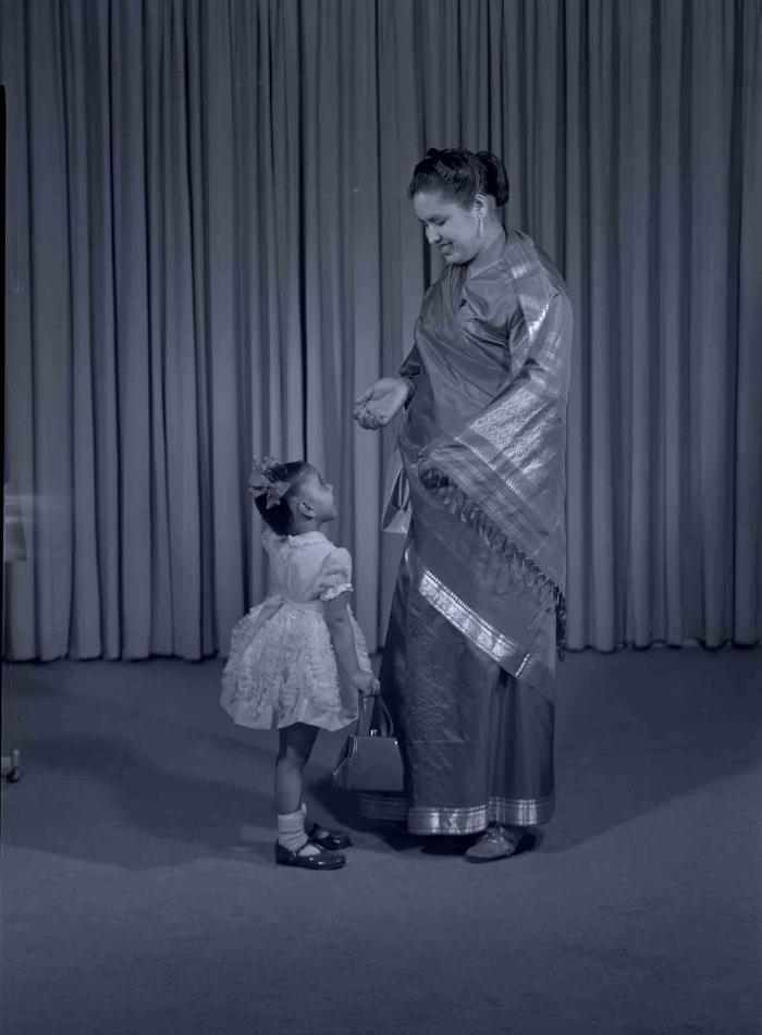 [Photo of Sarjit Kaur with a young child]