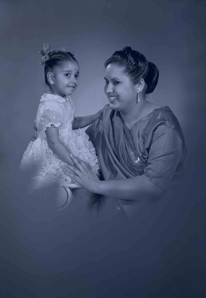 [Photo of Sarjit Kaur with a young child]