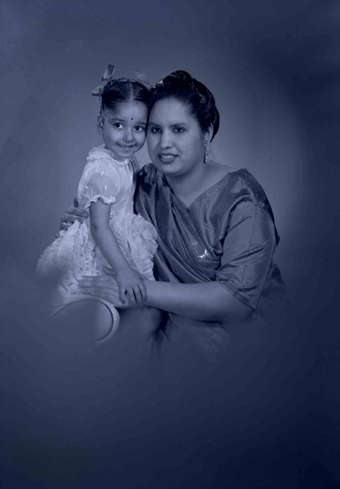 [Photo of Sarjit Kaur with a young child]
