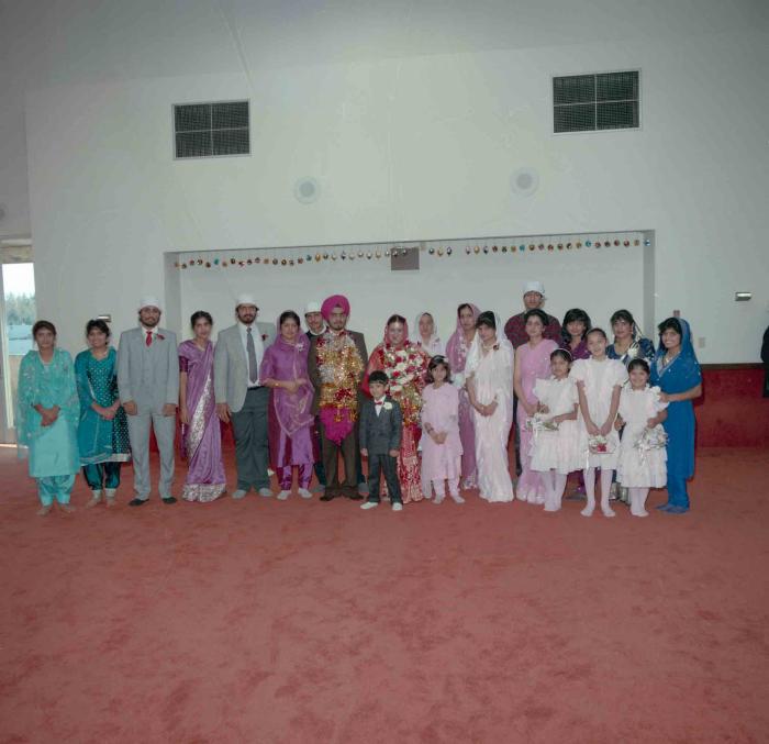 [Photo of Iqbal Mahol and Manjinder Nagra with their wedding guests]