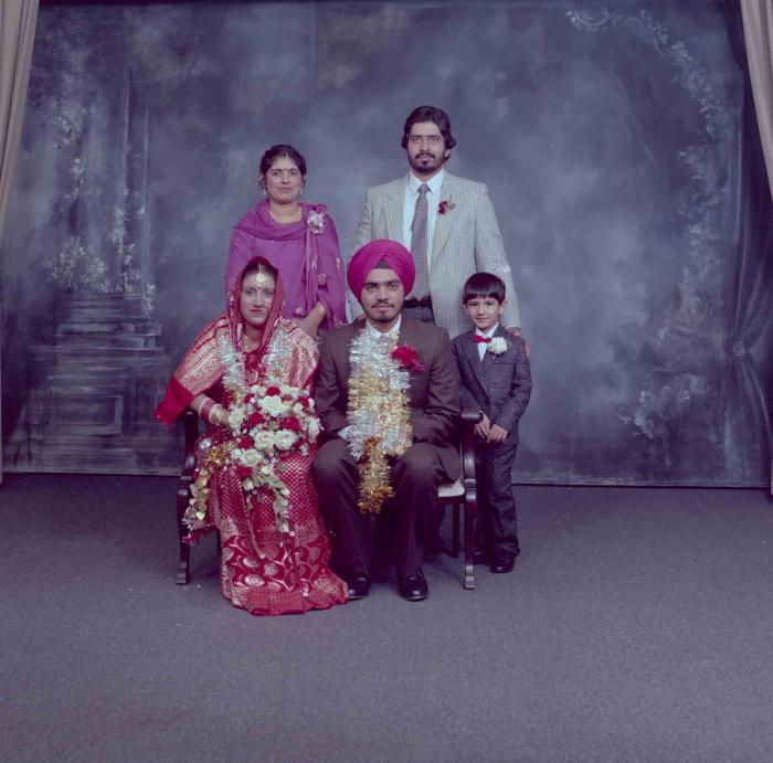 [Photo of Iqbal Mahol and Manjinder Nagra with their wedding guests]