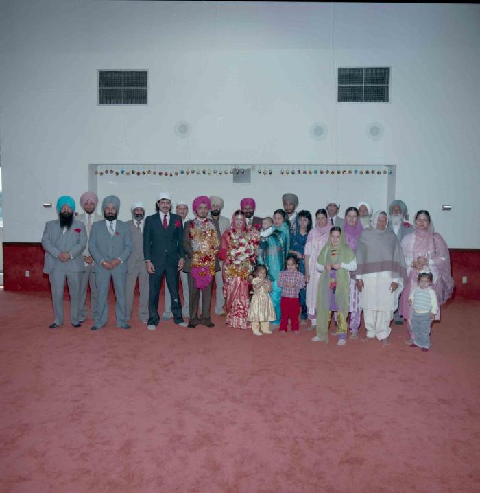[Photo of Iqbal Mahol and Manjinder Nagra with their wedding guests]