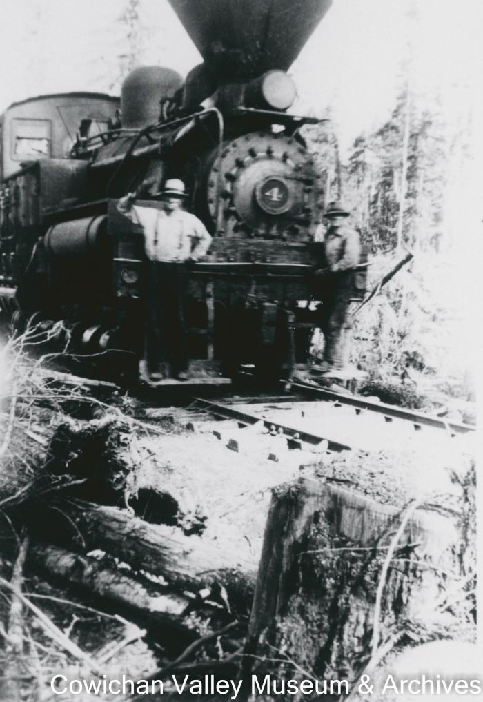 Two men posing with a locomotive