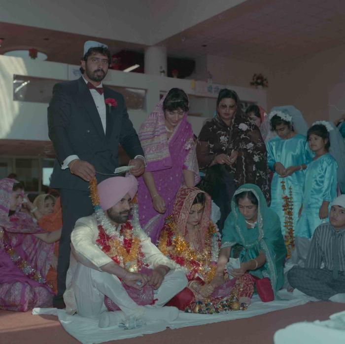 [Group photo of Nav Sunner and Parmvir Mann with wedding guests]