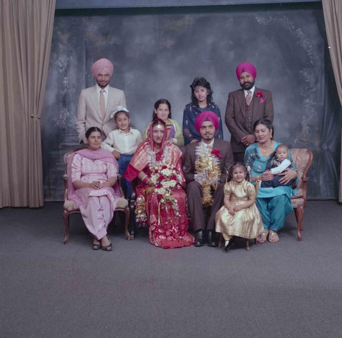 [Photo of Iqbal Mahol and Manjinder Nagra with their wedding guests]