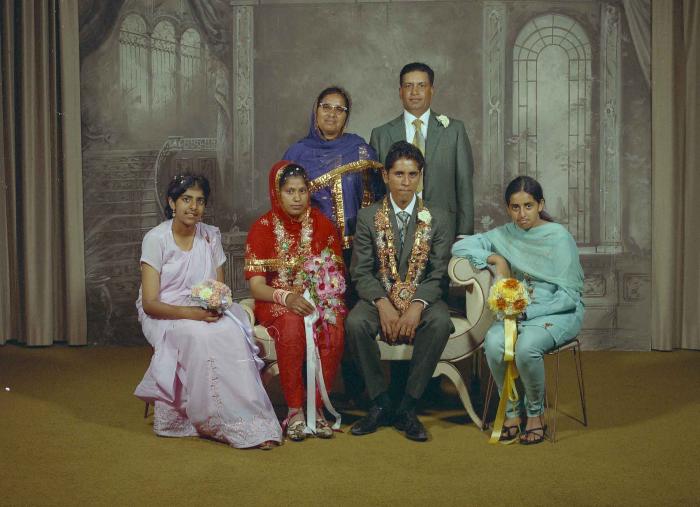 [Group photo of unidentified bride and groom with wedding guests]