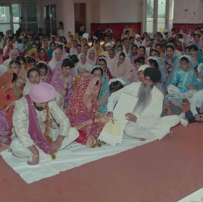 [Group photo of Nav Sunner and Parmvir Mann with wedding guests]