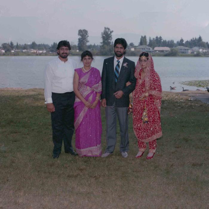 [Group photo of Nav Sunner and Parmvir Mann with wedding guests]