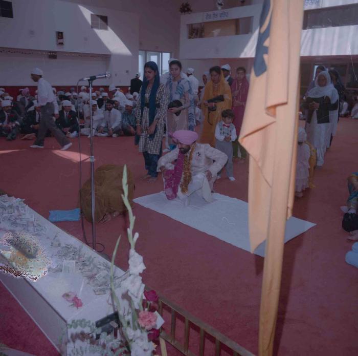 [Group photo of Parmvir Mann with wedding guests]