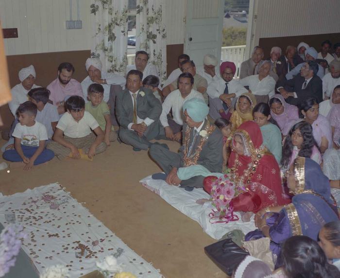 [Group photo of unidentified bride and groom with wedding guests]