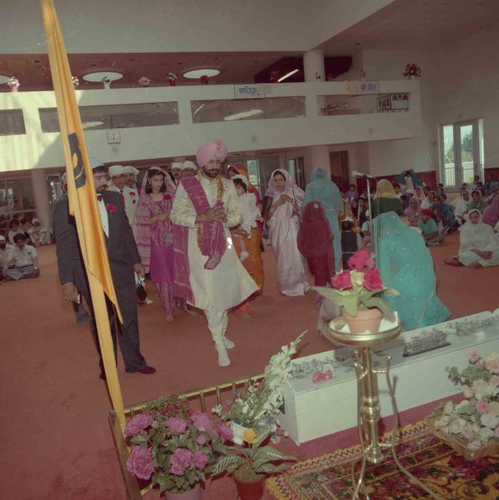 [Group photo of Parmvir Mann with wedding guests]