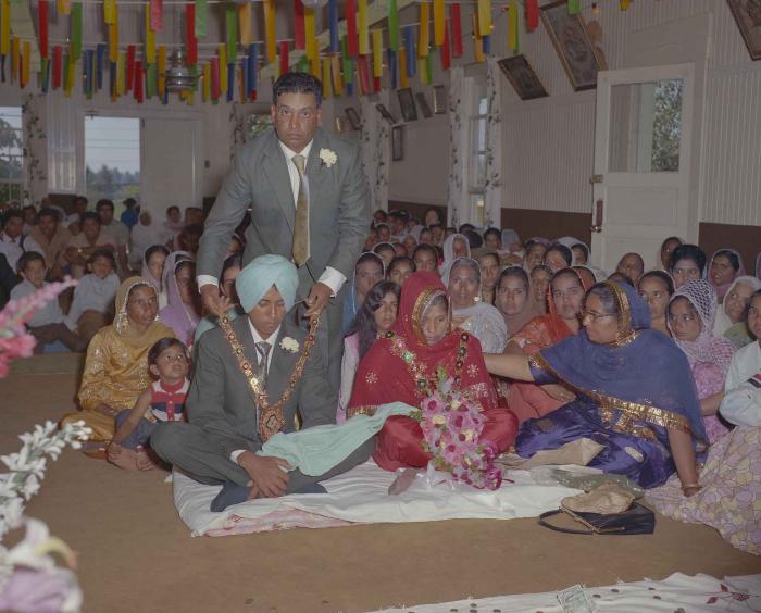 [Group photo of unidentified bride and groom with wedding guests]