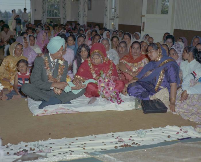 [Group photo of unidentified bride and groom with wedding guests]