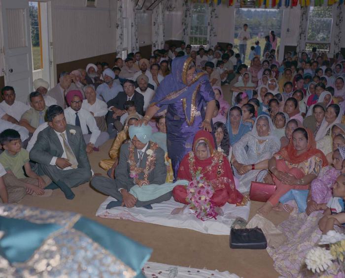 [Group photo of unidentified bride and groom with wedding guests]