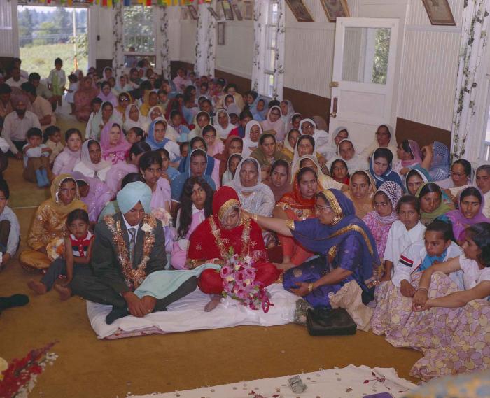[Group photo of unidentified bride and groom with wedding guests]