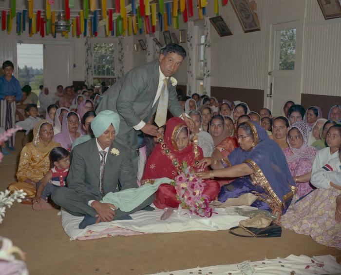 [Group photo of unidentified bride and groom with wedding guests]