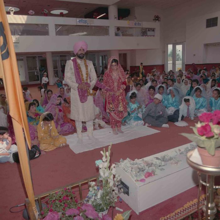 [Group photo of Nav Sunner and Parmvir Mann with wedding guests]
