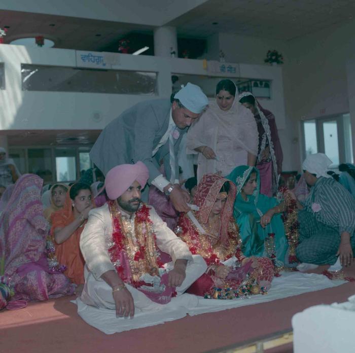 [Group photo of Nav Sunner and Parmvir Mann with wedding guests]