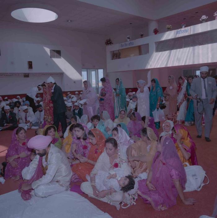 [Group photo of Parmvir Mann with wedding guests]