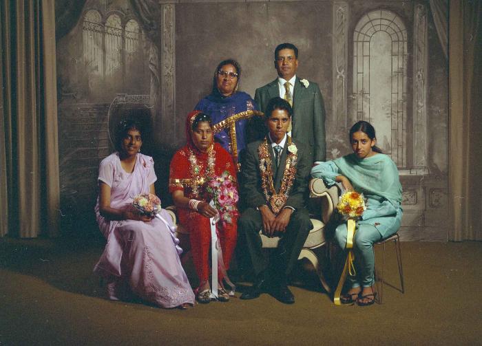 [Group photo of unidentified bride and groom with wedding guests]