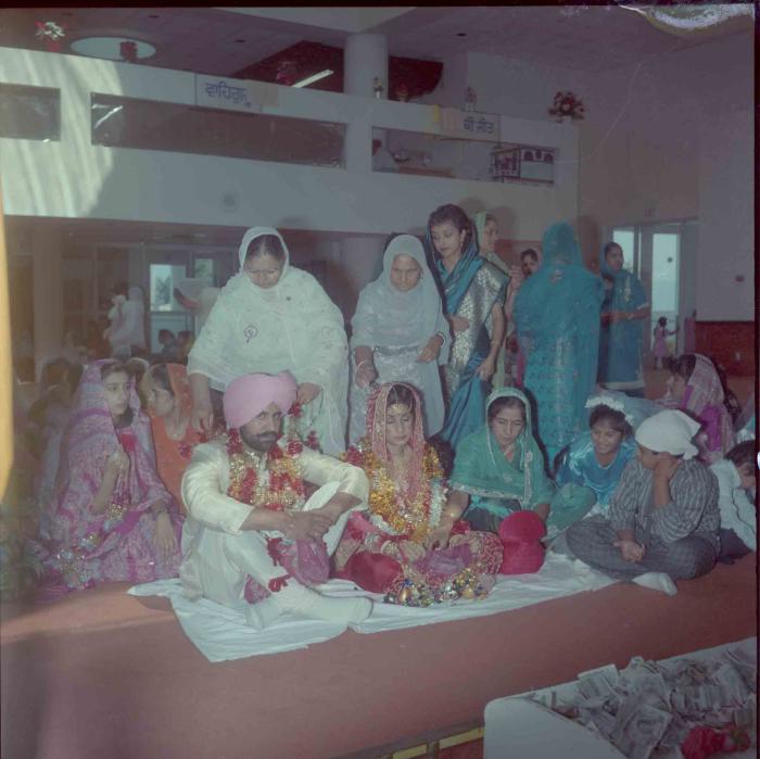 [Group photo of Nav Sunner and Parmvir Mann with wedding guests]