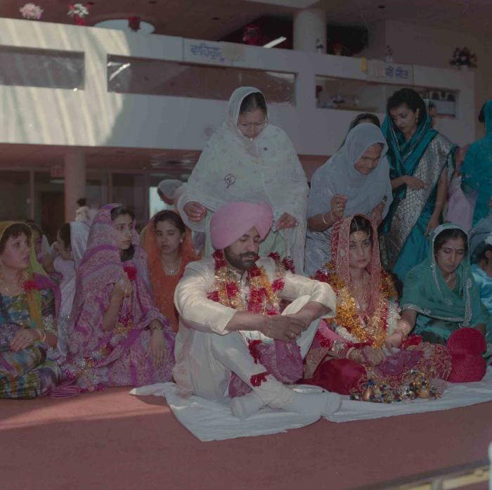 [Group photo of Nav Sunner and Parmvir Mann with wedding guests]