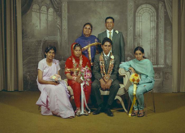 [Group photo of unidentified bride and groom with wedding guests]