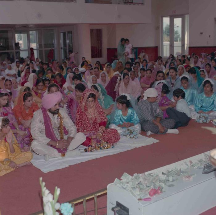 [Group photo of Nav Sunner and Parmvir Mann with wedding guests]