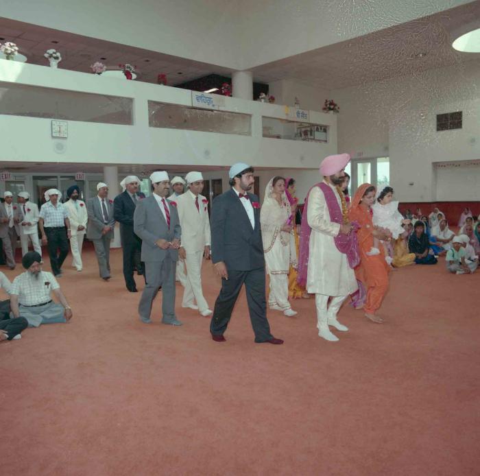 [Group photo of Parmvir Mann with wedding guests]