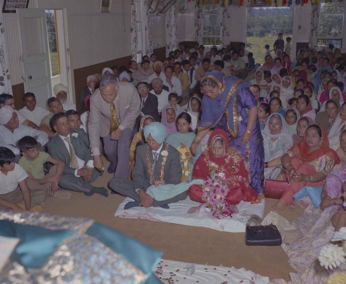 [Group photo of unidentified bride and groom with wedding guests]