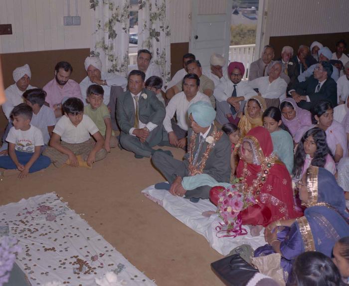 [Group photo of unidentified bride and groom with wedding guests]