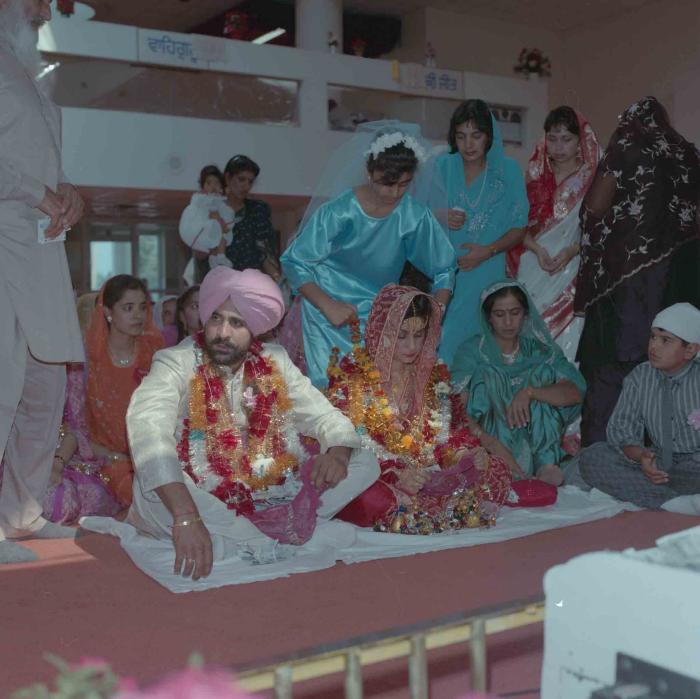 [Group photo of Nav Sunner and Parmvir Mann with wedding guests]