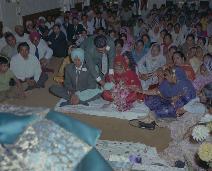 [Group photo of unidentified bride and groom with wedding guests]