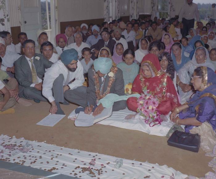 [Group photo of unidentified bride and groom with wedding guests]