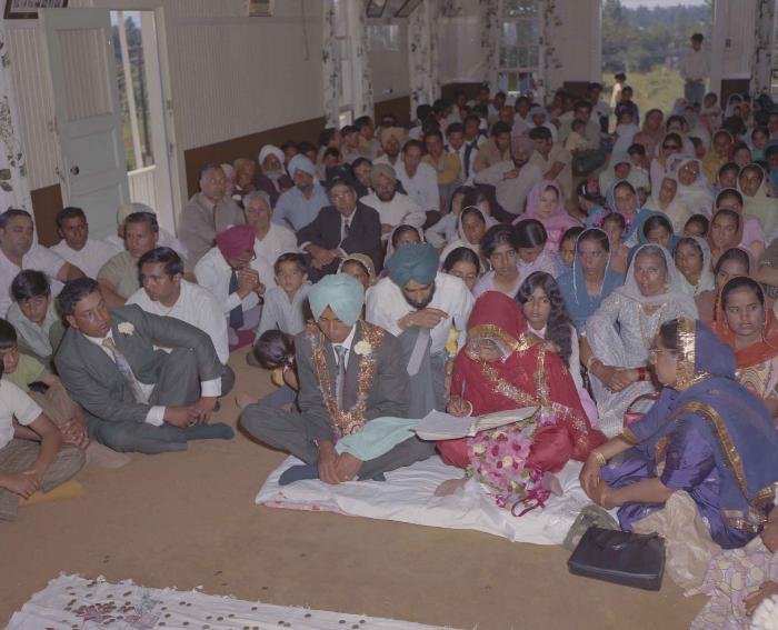 [Group photo of unidentified bride and groom with wedding guests]