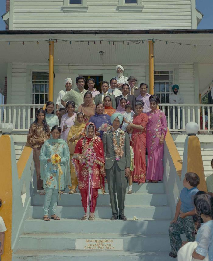 [Group photo of unidentified bride and groom with wedding guests]