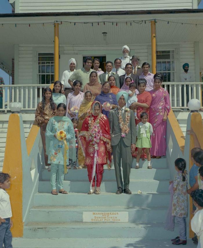 [Group photo of unidentified bride and groom with wedding guests]