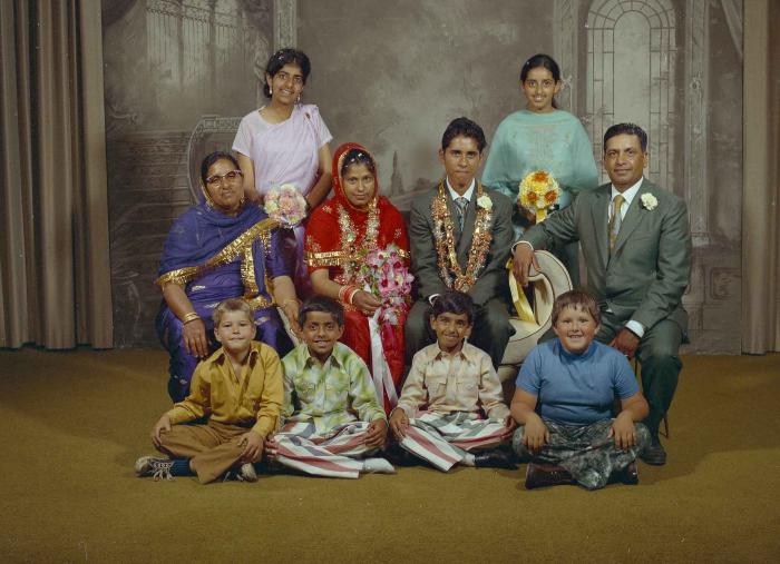 [Group photo of unidentified bride and groom with wedding guests]