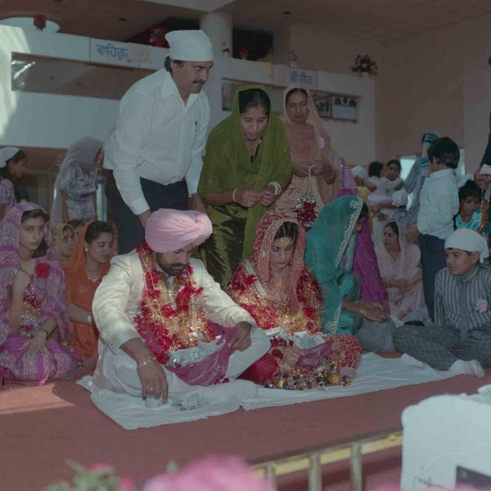 [Group photo of Nav Sunner and Parmvir Mann with wedding guests]