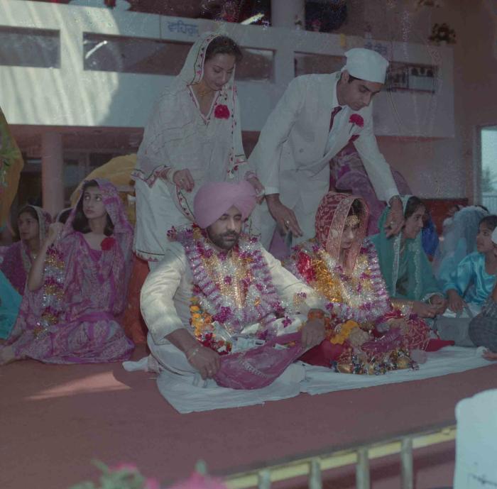 [Group photo of Nav Sunner and Parmvir Mann with wedding guests]