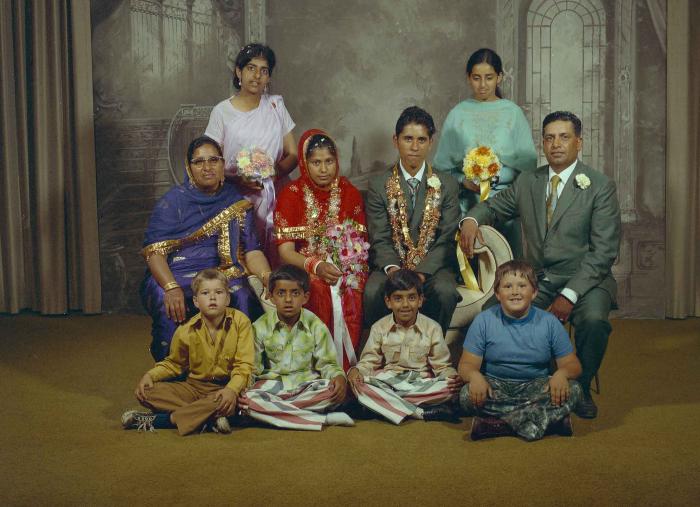 [Group photo of unidentified bride and groom with wedding guests]
