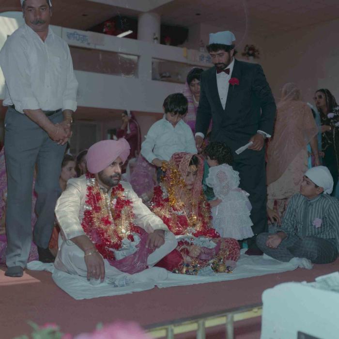 [Group photo of Nav Sunner and Parmvir Mann with wedding guests]